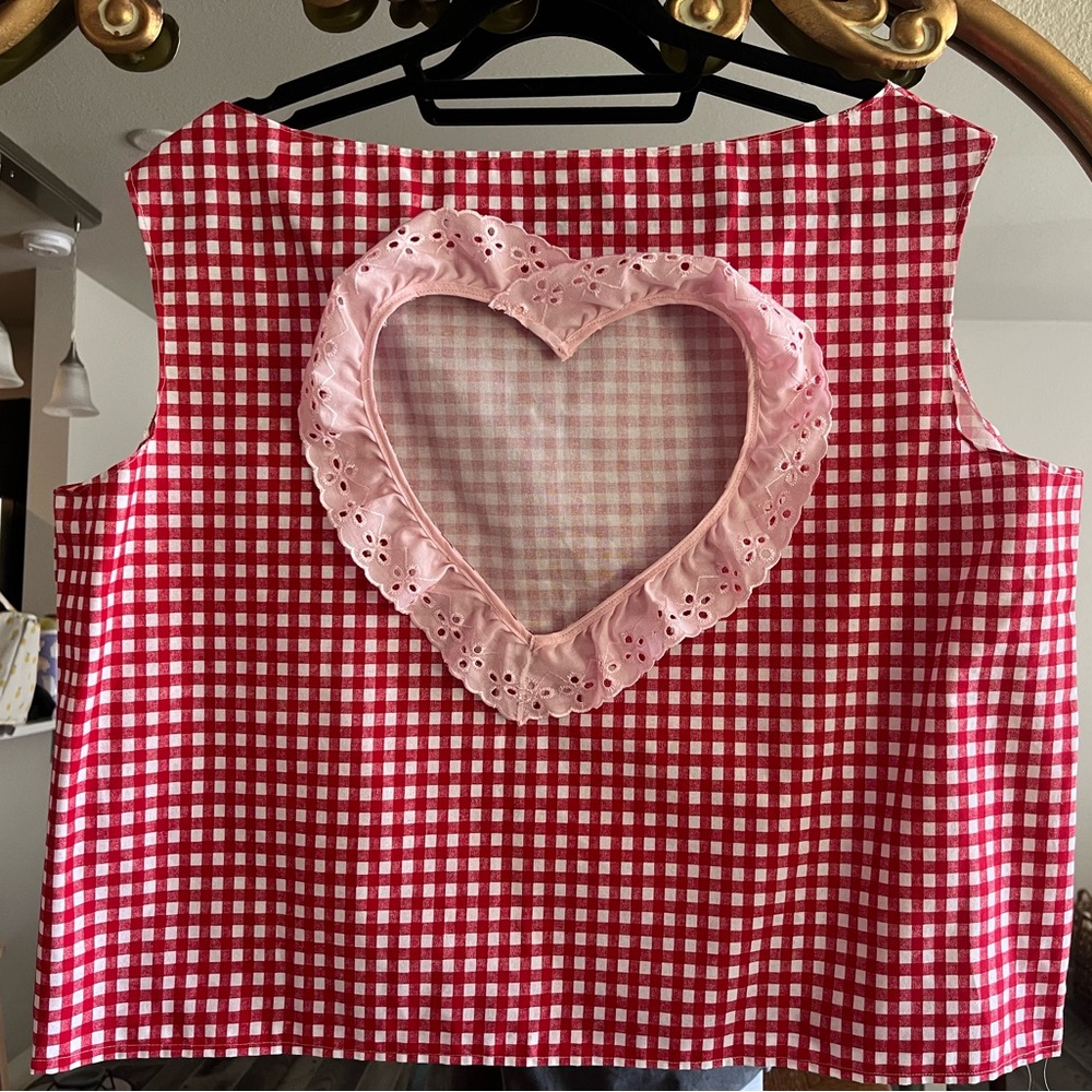 cute sleeve-less shirt with heart shape cut out on back!